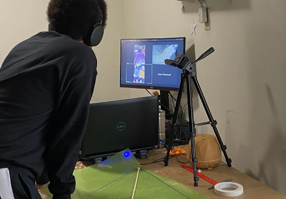 Teen Tech Squad leader uses camera and computer to work on a project with squad participants virtually