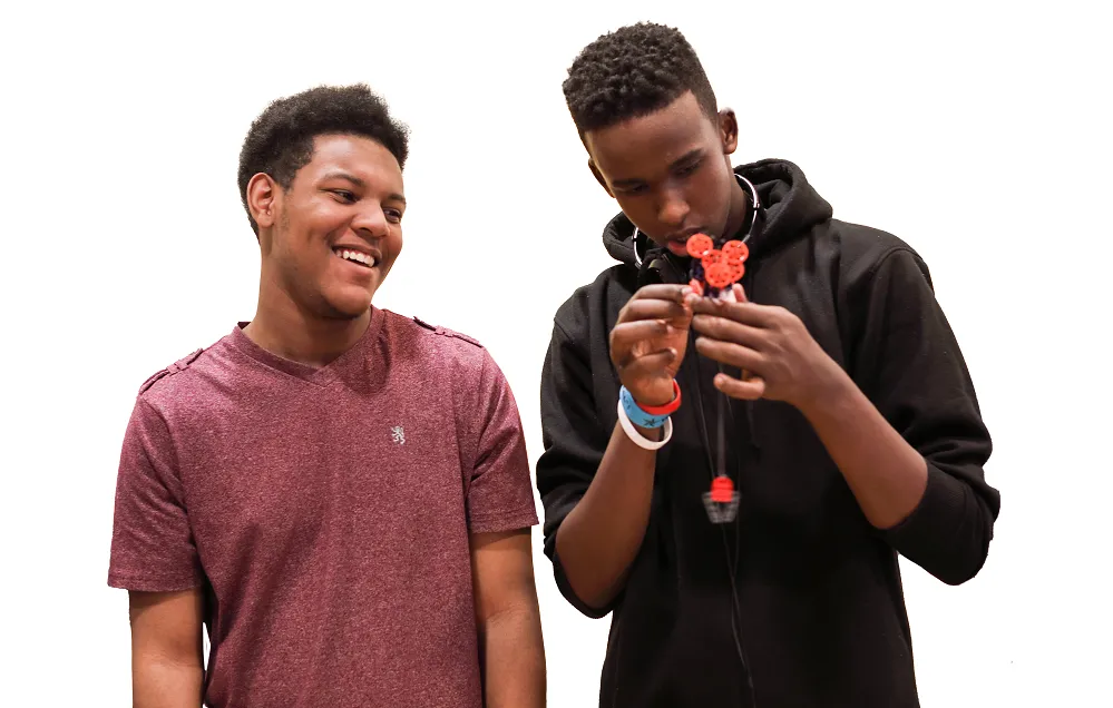 Two teens working together on STEM project having fun