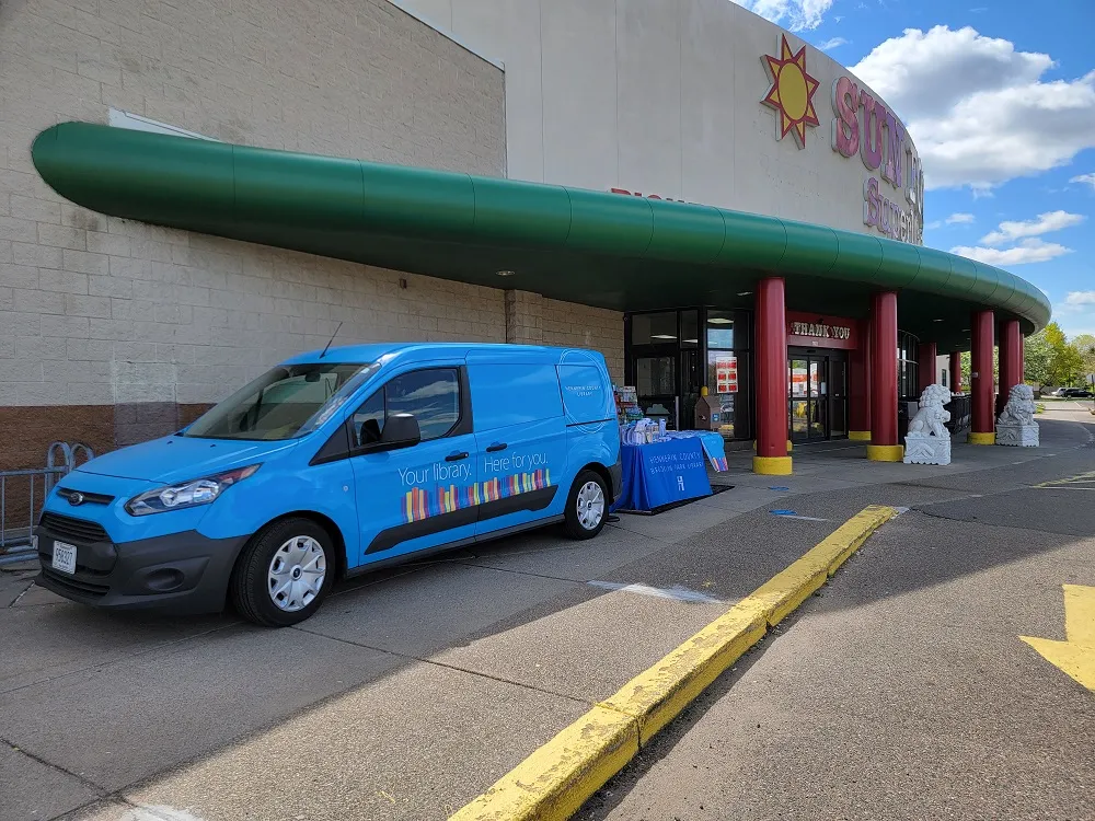 The library van parked outside of a grocery store
