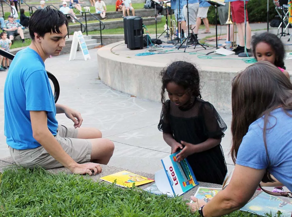Kids reading books sitting in the grass