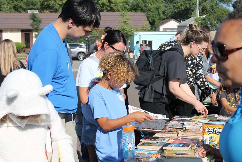 A boy picking out a new book at Summer Reading Festival