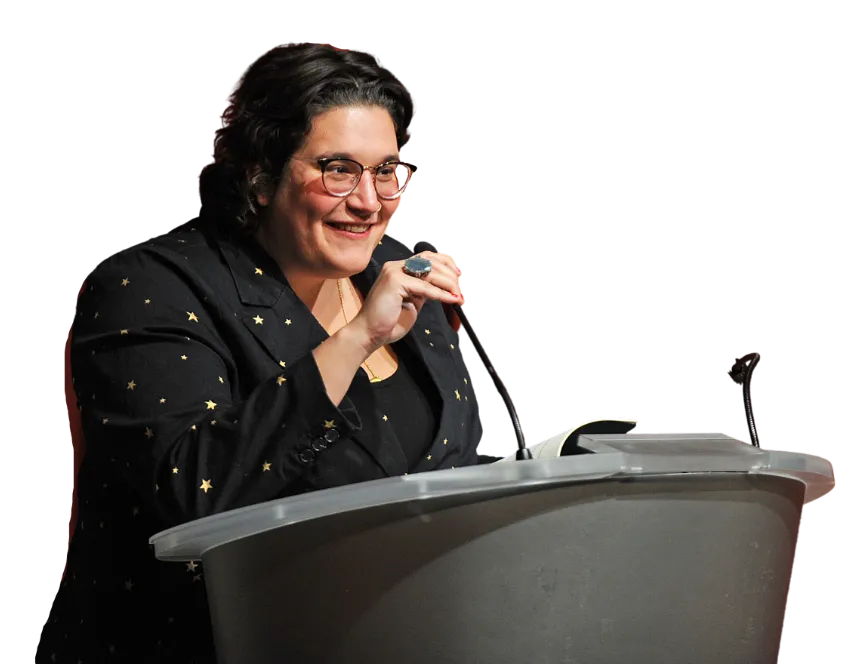 Carmen Maria Machado reads from her book "Dream Land" at a podium.