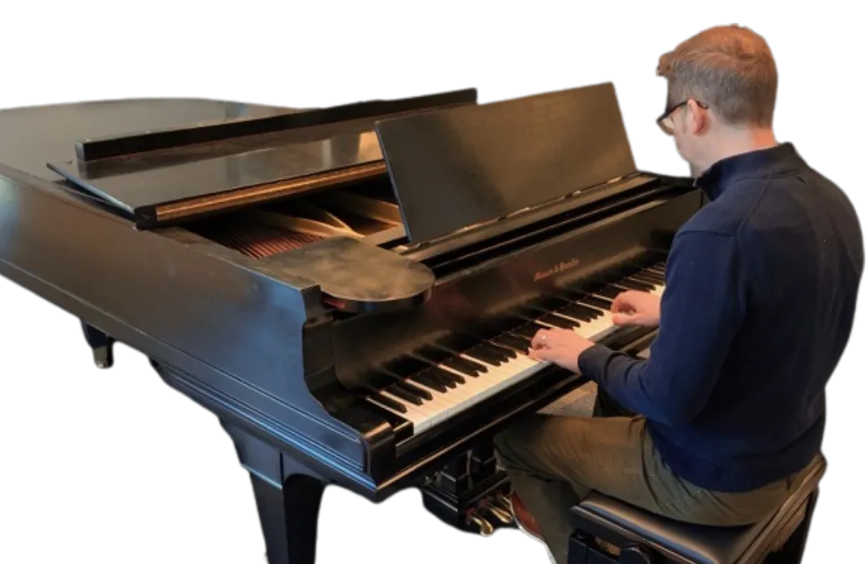 Man plays the piano at Minneapolis Central Library's piano room.