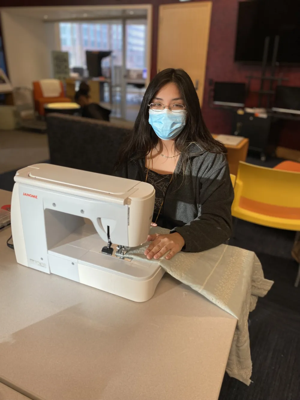 A young woman operates a sewing machine at the Best Buy Teen Tech Center