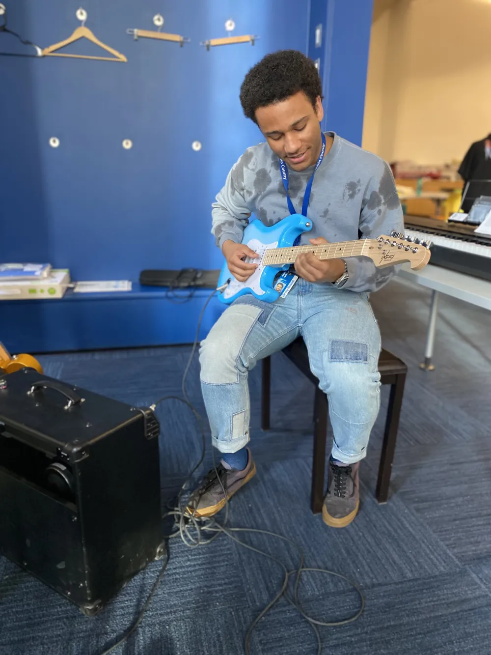 A young man plays an electric guitar, one of the features of Minneapolis Central Library's Best Buy Teen Tech Center