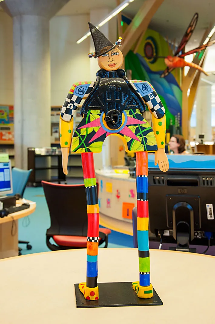 A whimsical statue stands in the foreground of the children's area at Minneapolis Central Library.