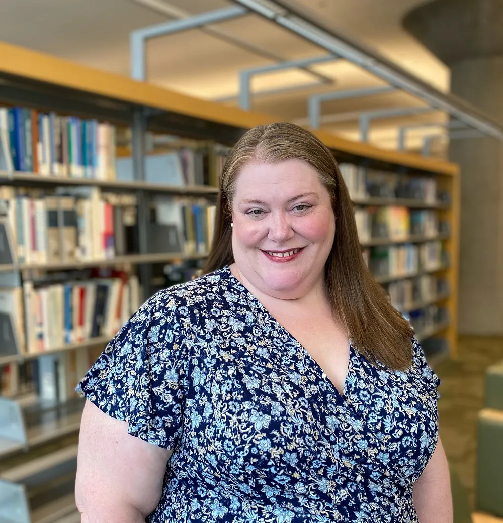Portrait of Jennifer Vickerman in front of the stacks at Minneapolis Central Library
