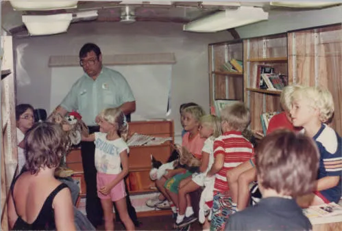 Children with Bookmobile librarian Dan Kelty, 1990s