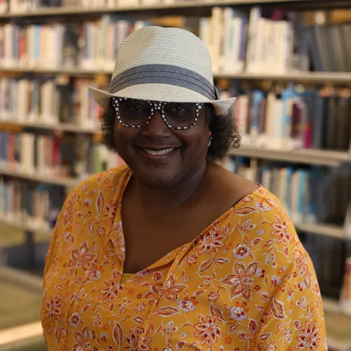 Portrait of Gale Cannon in front of the stacks at Minneapolis Central Library