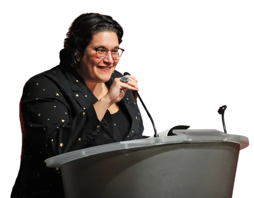 Carmen Maria Machado reads from her book "Dream Land" at a podium.