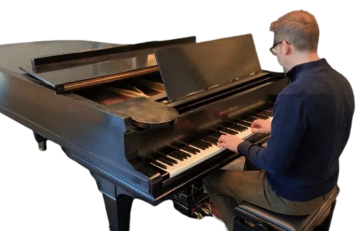 Man plays the piano at Minneapolis Central Library's piano room.