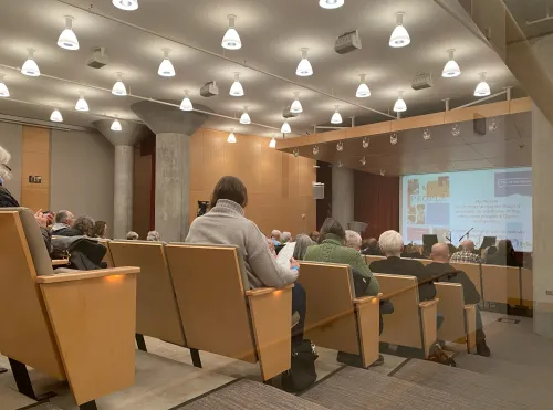 An audience sits and prepares for an event at Minneapolis Central Library's Pohlad Hall.