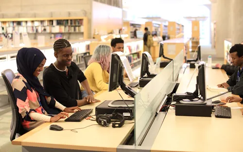 A group of teens enjoy the computer stations at Minneapolis Central Library
