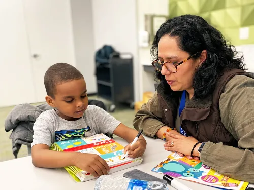 Eden Prairie Library Lead Tutor works with a student at Homework Help program