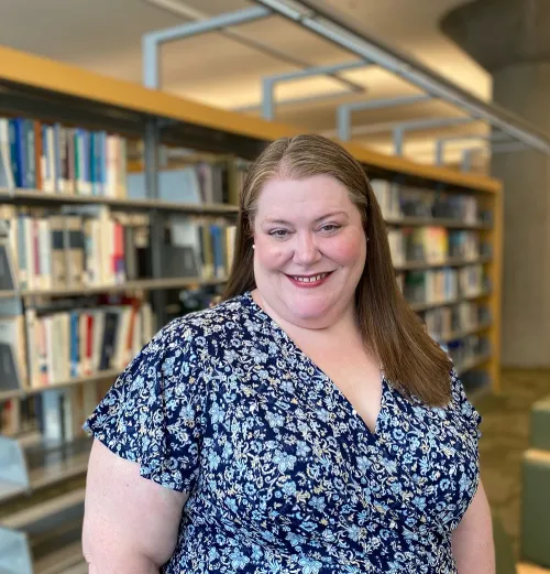 Portrait of Jennifer Vickerman in front of the stacks at Minneapolis Central Library