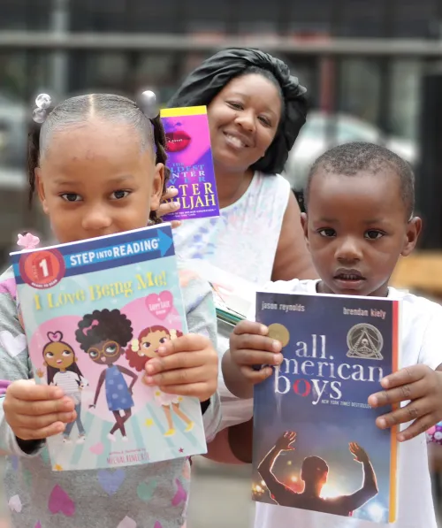 A family poses with their new gifted books.