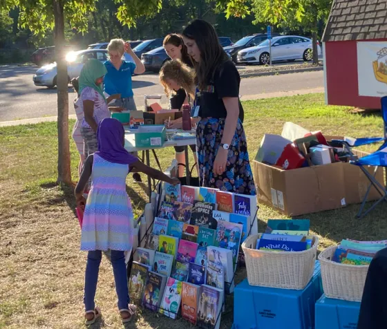 A girl picking out a new book at summer reading festival