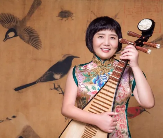 Headshot of Gao Hong playing the Chinese Pipa.