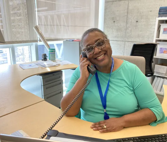 Gale Cannon, Development associate at Friends, is captured candidly in a smile as she speaks to a FHCL donor on the phone. 
