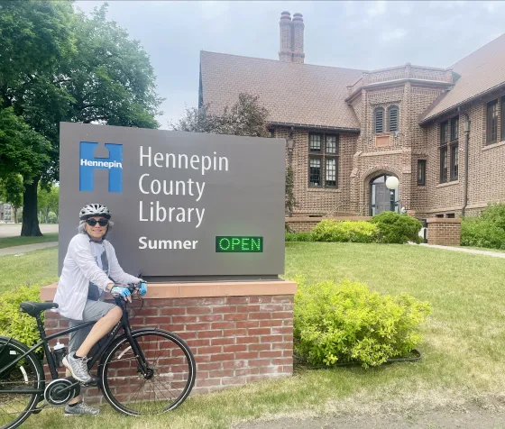 Rosa poses on her bike outside Sumner Library