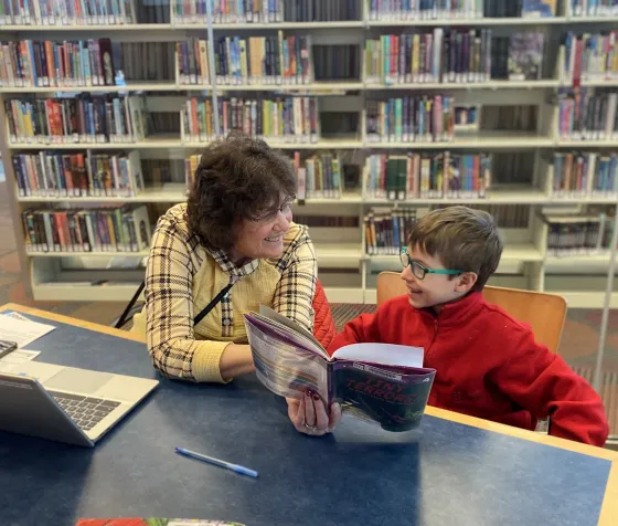 Brody smiles at his tutor, Sue. 