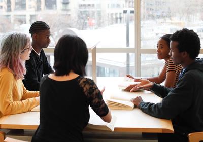 A teen book group around a table