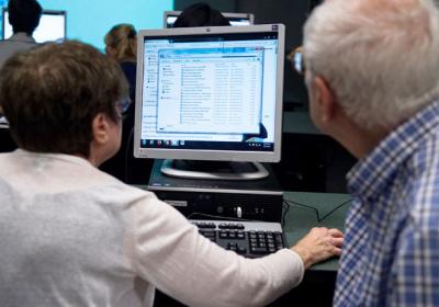 Seniors use a computer at a technology literacy workshop