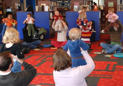 Caregivers play with their babies at an early learning event