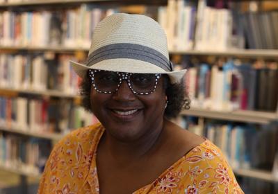 Portrait of Gale Cannon in front of the stacks at Minneapolis Central Library