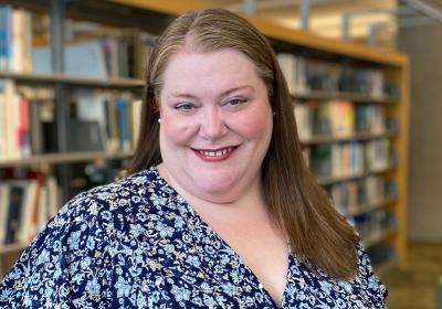 Portrait of Jennifer Vickerman in front of the stacks at Minneapolis Central Library