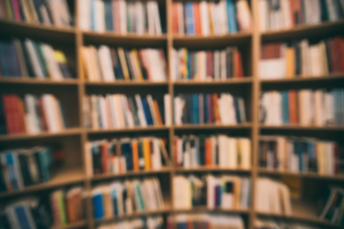 A blurred book shelves with multicolored books