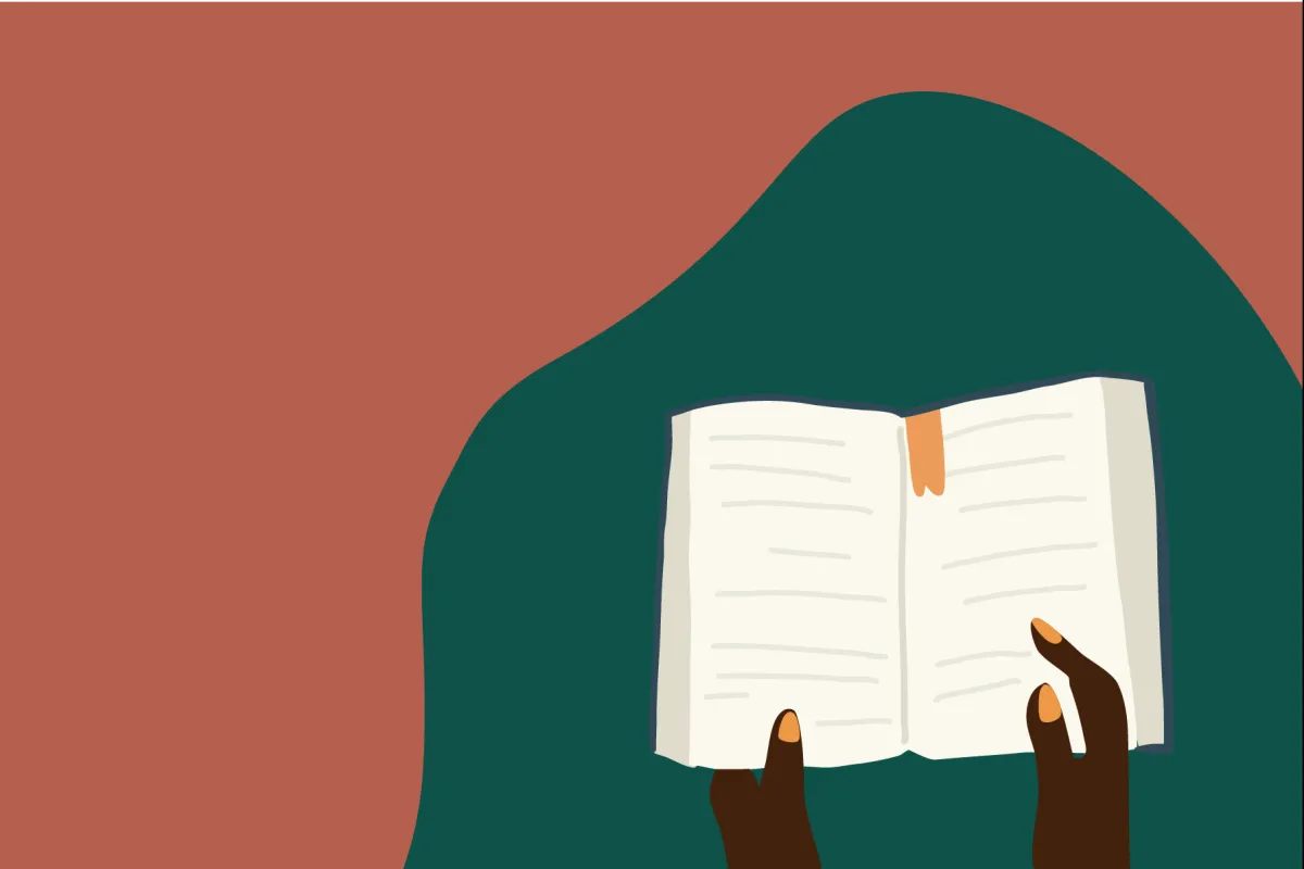 Black hands holding an open book