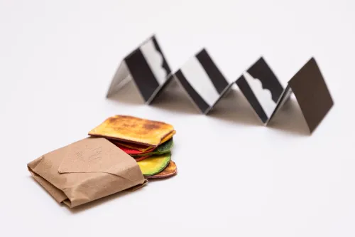 Karen Kinoshita's minature books, one shaped like a sandwich and one a black and white accordion book.