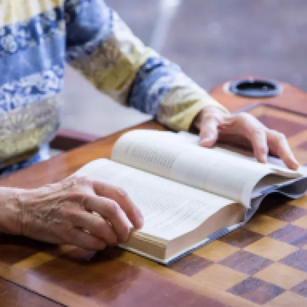 Person reading a large print book