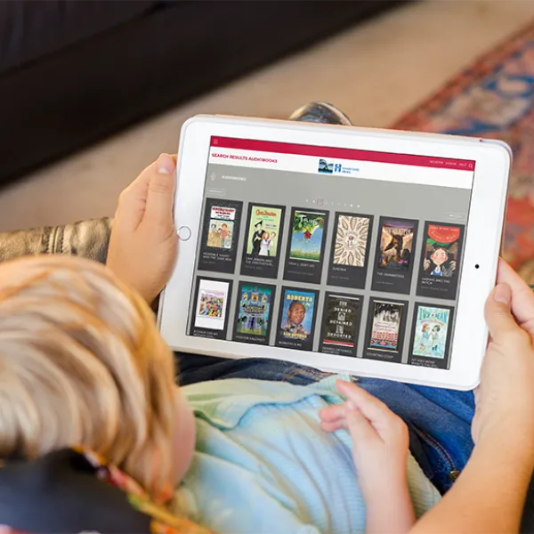 Woman reading e-book on an iPad with boy