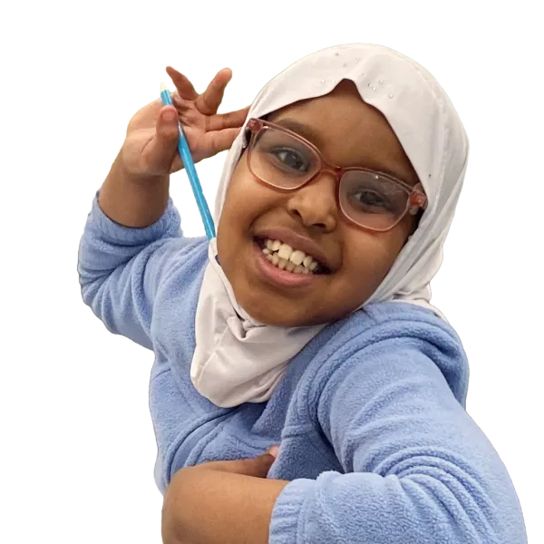 Little girl smiling while doing homework