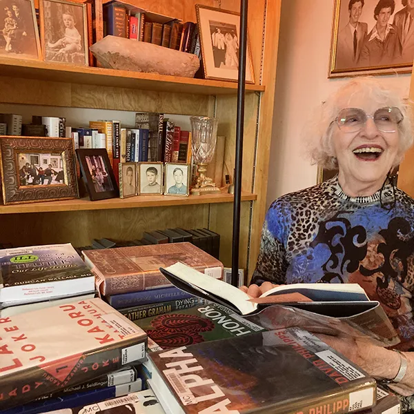 Nancy Strauss at her home with her library books